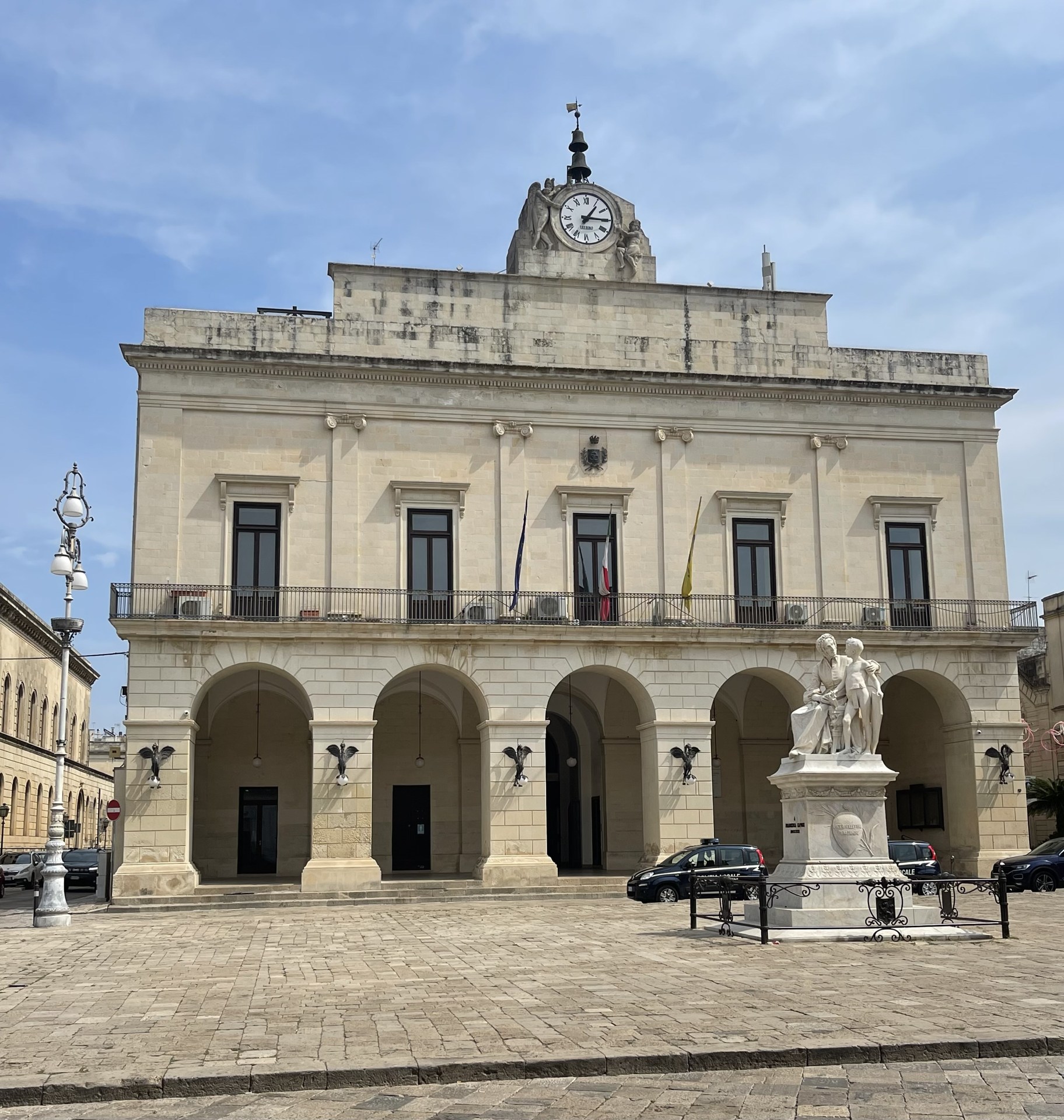 Historic arcades and a monument in Piazza Aldo Moro, Maglie