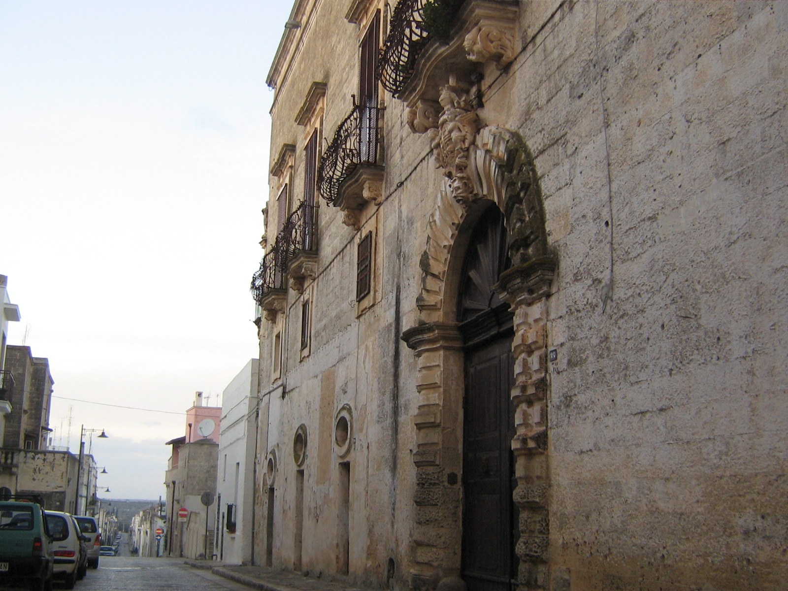 Historic stone façades along a street in Specchia