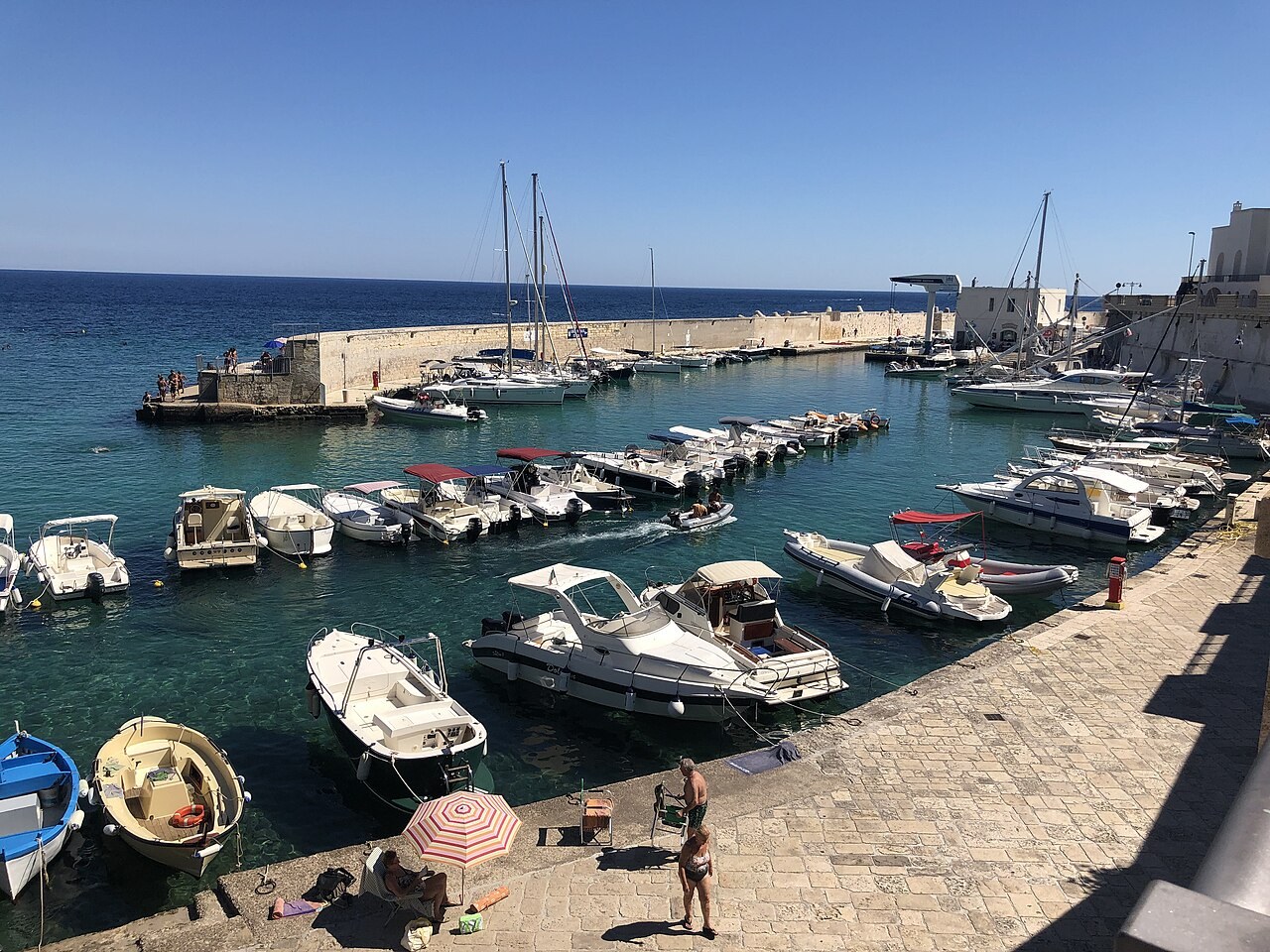 Fishing boats and blue water in the harbour at Tricase Porto
